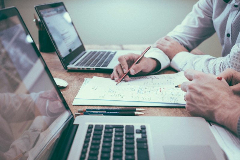 Analysts reviewing campaign documents to define metrics and an experiment roadmap